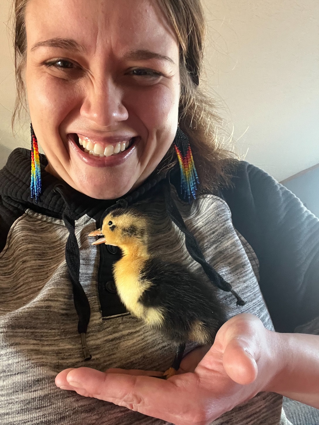 Photo of Tori Smith holding duck chick with glee